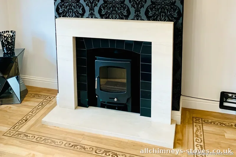 Saltfire 5kW multifuel stove installation, black tiled arched opening, limestone surround, Hornchurch