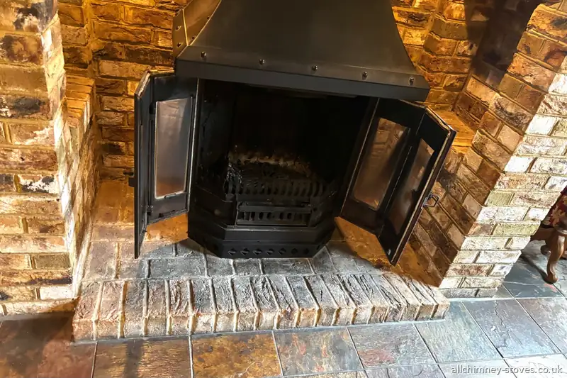 12kW double door wood burning stove, bespoke canopy hood, inglenook brick setting, slate hearth, Rise Park Romford