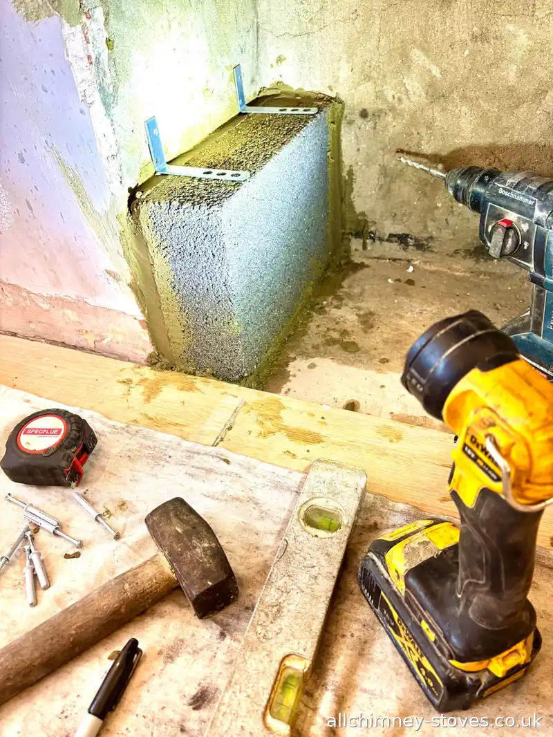 Fireplace opening reduction in progress, high density blockwork with stainless steel brick ties, hearth construction, Upminster