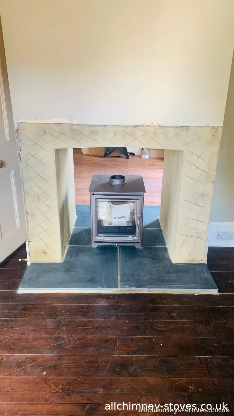 HETAS certified wood burner installation — log burner positioned on slate hearth prior to 125mm chimney lining and commissioning, Allchimney Stoves, Harold Wood