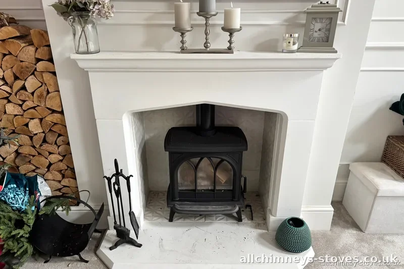 HETAS certified wood burning stove installation — gothic arch decorative stone fireplace, patterned tiles, Allchimney Stoves, Hornchurch